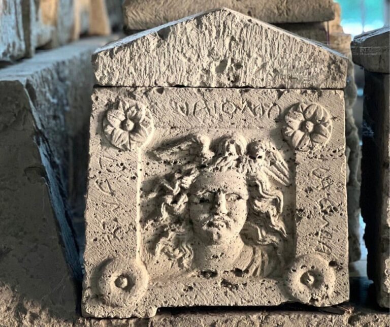 Travertine urn from the Palazzone Necropolis in Perugia, carved with the face of Medusa and floral motifs